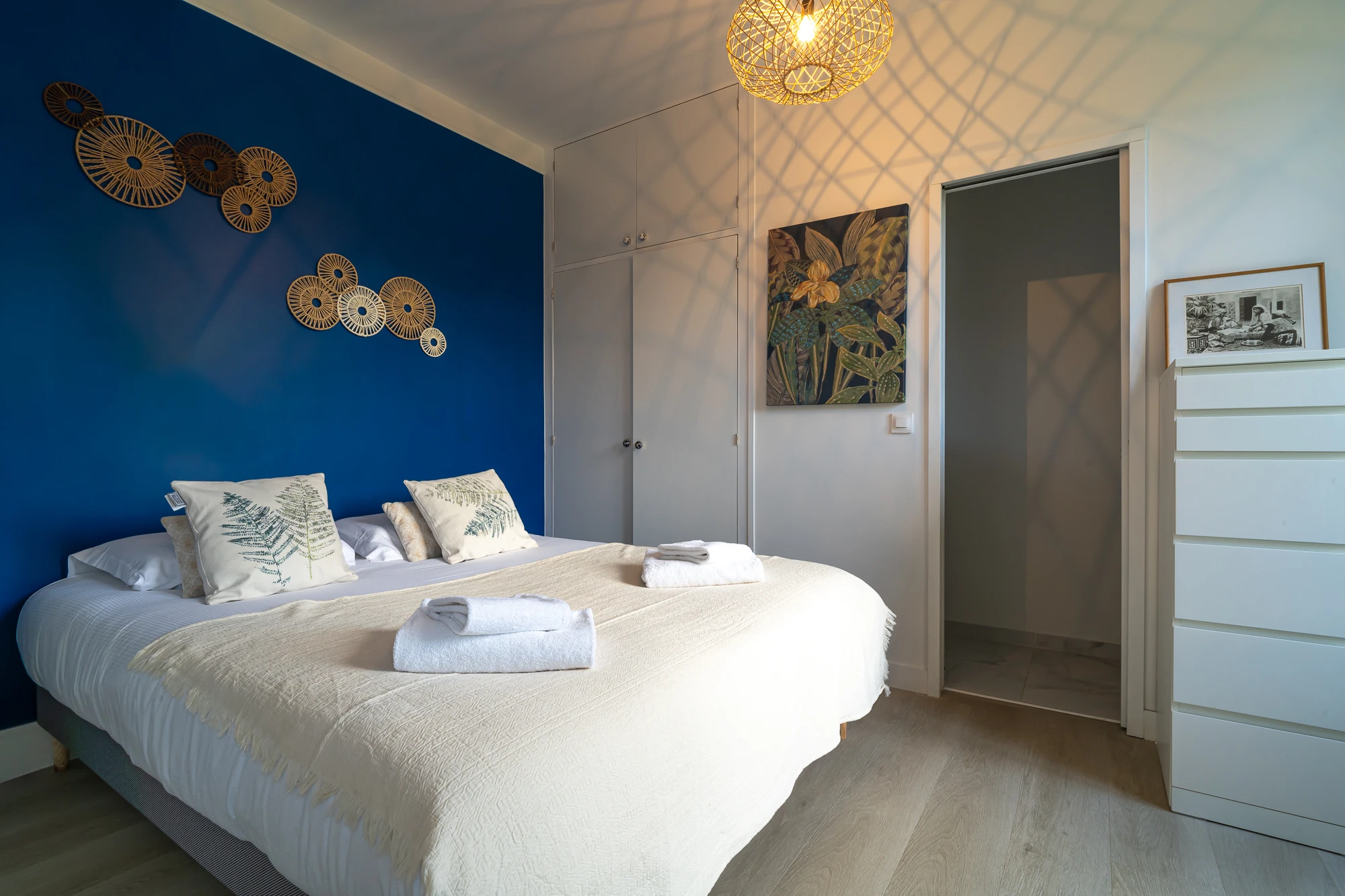 Chambre décorée en bleu – Evasion Normande Chambre lumineuse avec mur bleu décoratif et lit double dans la maison Evasion Normande.